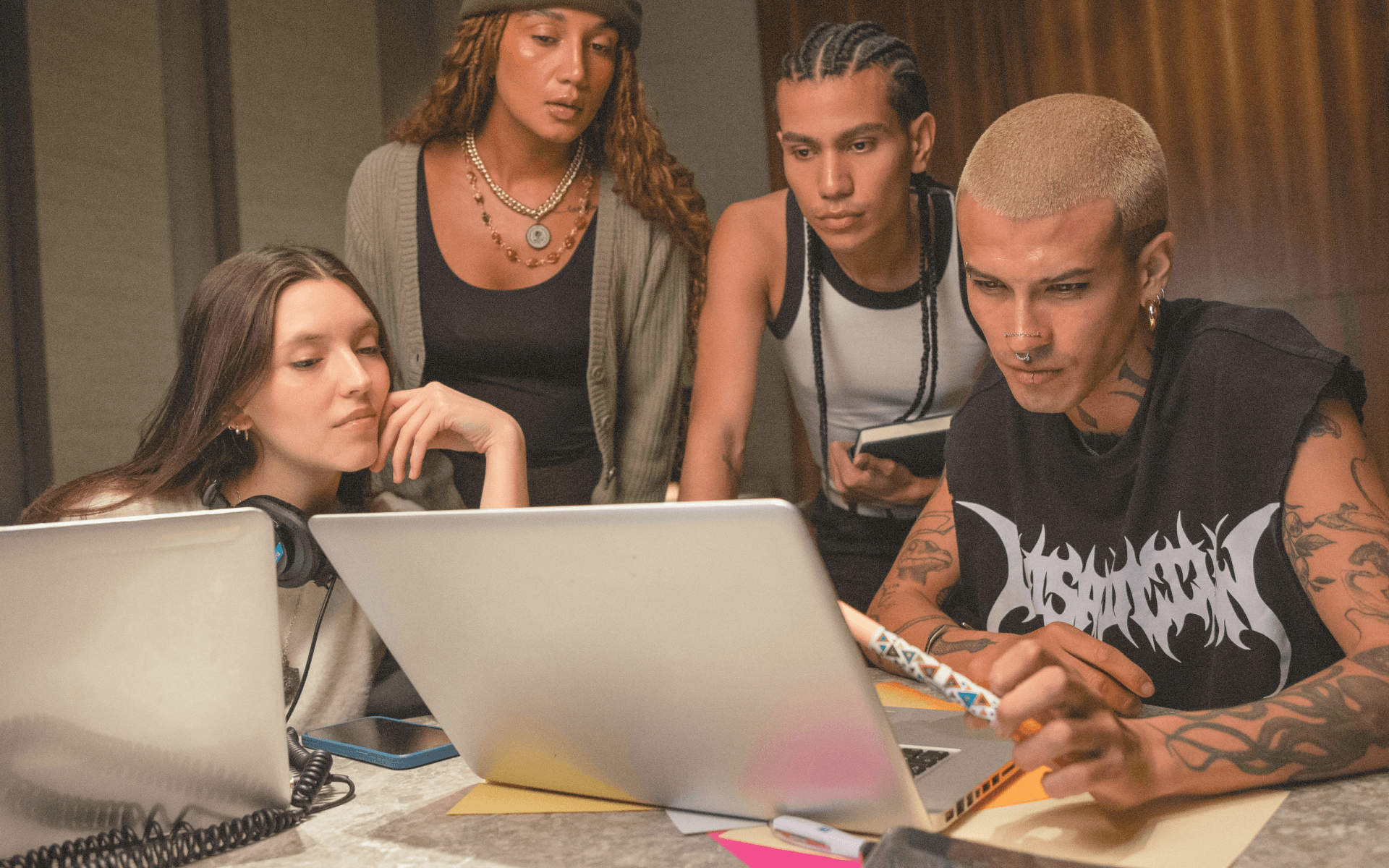 A creative team gathered around laptops